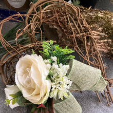 A heart wreath with artificial roses and foliage