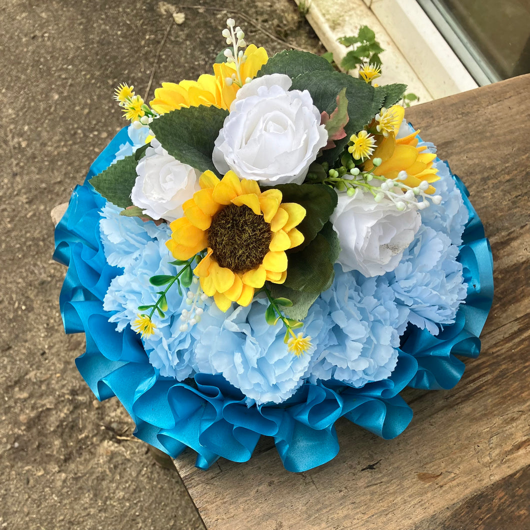 A based posy of silk roses and lily flowers in shades of blue and white