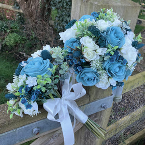 A wedding bouquet collection of ivory and teal flowers and foliage