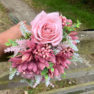 A brides posy featuring artificial pink silk gerbera and roses