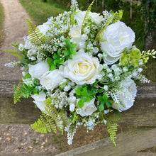 A wedding bouquet collection of white artificial silk roses peonies and gyp