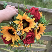a wedding bouquet featuring artificial red roses, gyp & sunflowers