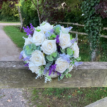 A wedding bouquet of artificial ivory roses & lavender flowers