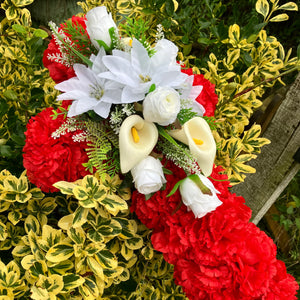 Memorial cross of artificial silk roses and carnations
