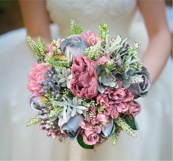 A wedding bouquet of artificial mauve and blue flowers