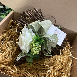 A heart wreath with cluster of flowers and foliage