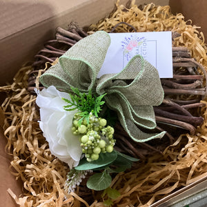 A heart wreath with cluster of flowers and foliage