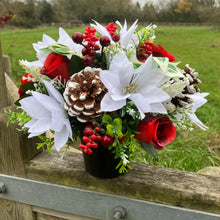 A memorial Christmas flower rose and poinsettia arrangement