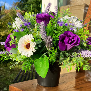 a grave pot with cream artificial silk gerbera and rose blooms