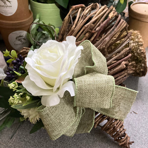 A heart wreath with faux roses and foliage