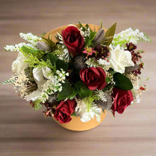 Gold hat box with artificial roses and thistle flowers