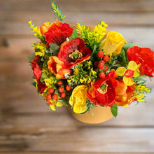 Gold hat box with artificial red and yellow flowers and berries