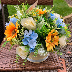An artificial flower arrangement in cream hat box