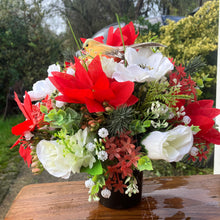 An artificial graveside flower arrangement in pot