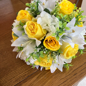 A wedding bouquet collection of yellow and ivory silk flowers