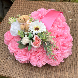 a personalised memorial heart of artificial silk roses and carnations in shades of pink