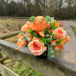 grave pot with faux silk roses and lilies