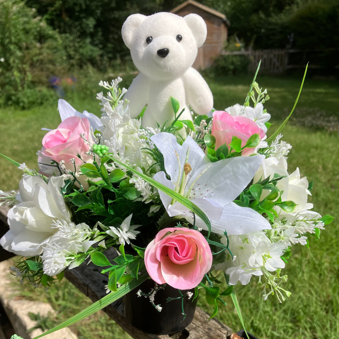 a grave pot with roses and lilies plus flocked teddy