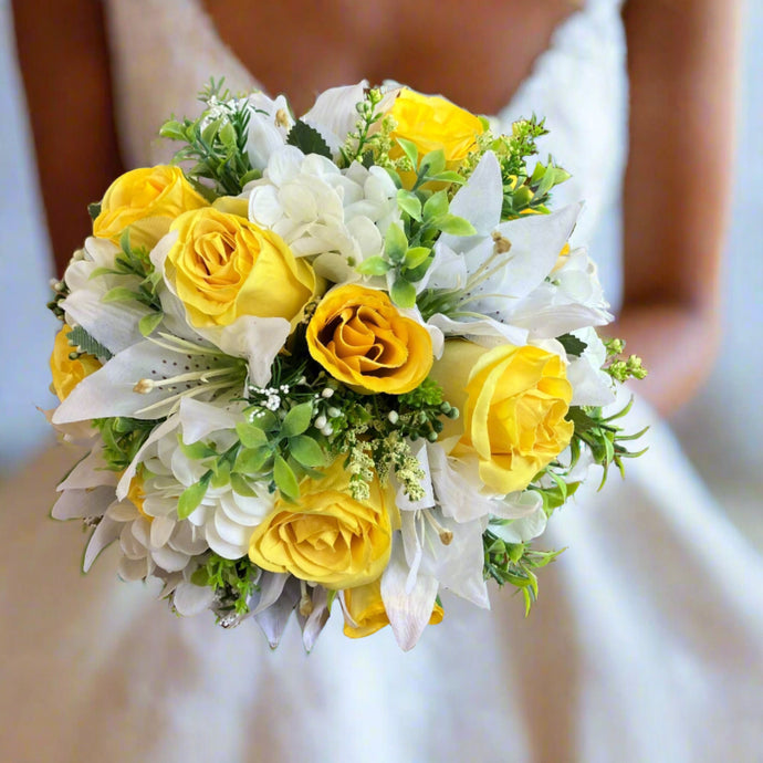 A wedding bouquet collection of yellow and ivory silk flowers