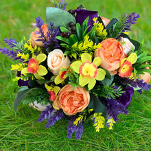 a grave pot with flowers featuring  artificial silk blooms