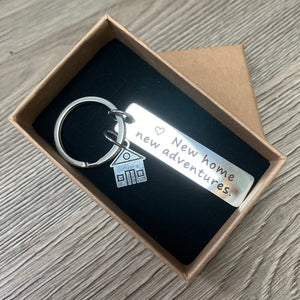 Stainless steel keyring with ‘new home, new adventures’ token