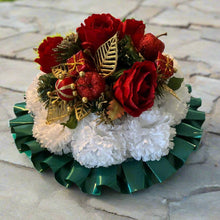 A christmas graveside memorial posy of red roses and carnations