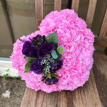 A memorial heart based in pink silk carnations