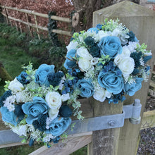 A wedding bouquet collection of ivory and teal flowers and foliage