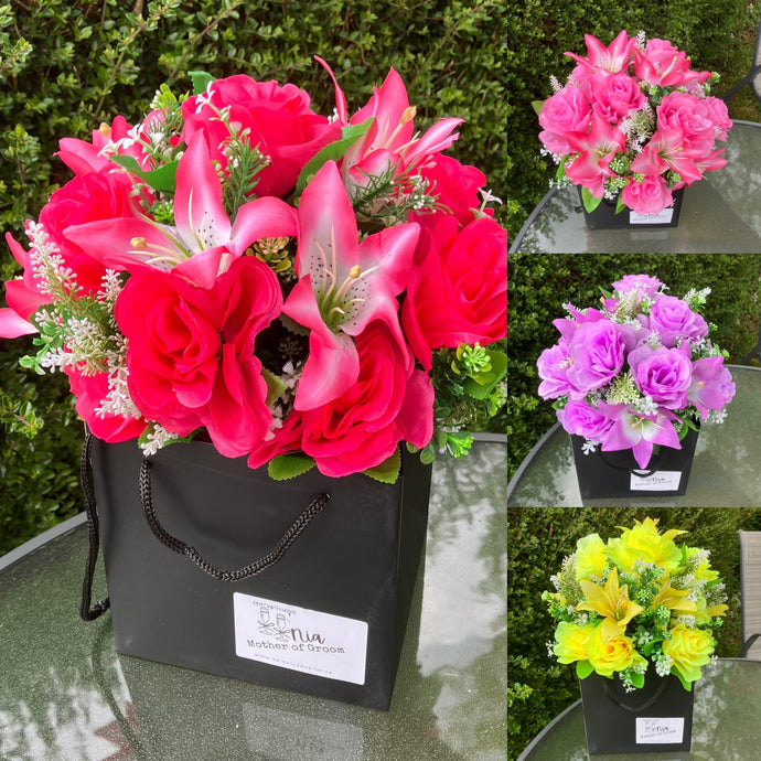 A handtied bouquet of artificial roses and lilies personalised message