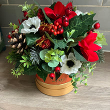 christmas flower arrangement in hat box