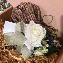 A heart wreath with faux roses and foliage