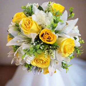 A wedding bouquet collection of yellow and ivory silk flowers