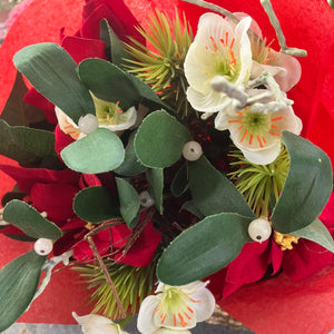 An Artificial flower bunch of christmas roses mistletoe and poinsettia