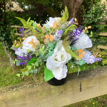 grave pot with flowers featuring artificial silk blooms