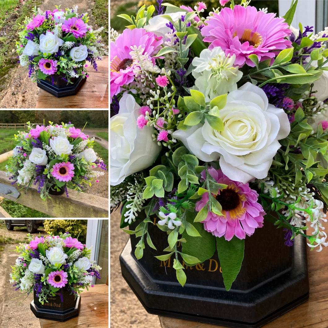 a graveside artificial flower arrangement in shades of cream and pink