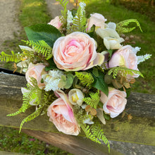 A brides bouquet featuring blush peach silk roses & orchids