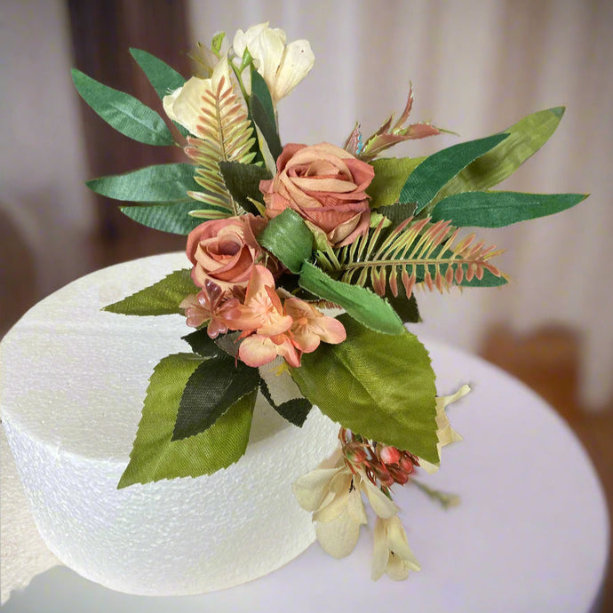 A dusky orange autumn artificial flower cake topper