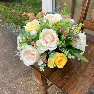 a grave pot with flowers featuring  artificial silk blooms