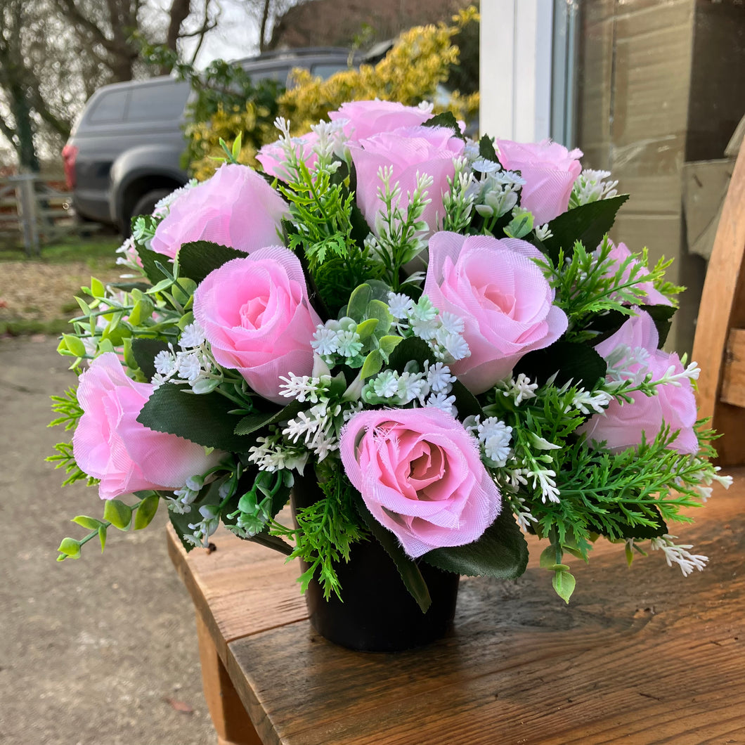 a grave pot flower arrangement featuring artificial pink rose flowers