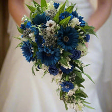 A teardrop wedding bouquet collection of gerbera and daisies