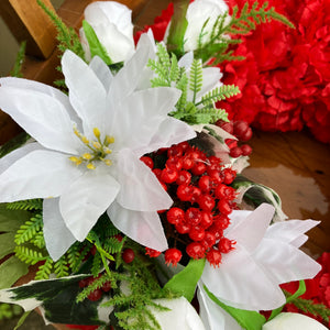 A lge memorial wreath with carnations roses and poinsettia flowers