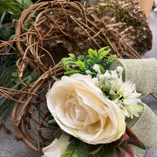 A heart wreath with artificial roses and foliage