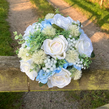 A brides bouquet of white/ivory and pale blue artificial silk flowers