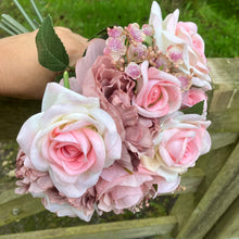 A wedding bouquet featuring silk  pink roses & peonies