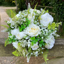 A wedding bouquet collection of white artificial silk roses peonies and gyp