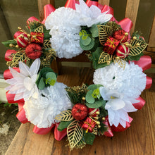 a memorial christmas wreath featuring parcels, cones and poinsettia