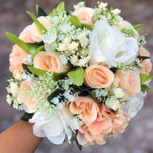 A wedding bouquet featuring silk flowers in shades of ivory and peach