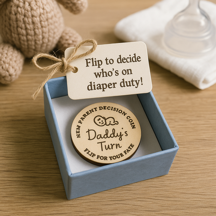 Wooden coin with 'Daddy's Turn' text in a blue box with a tag on a wooden surface.
