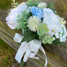 A brides bouquet of white/ivory and pale blue artificial silk flowers