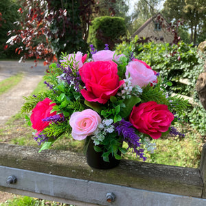 graveside artificial flower arrangement in shades of pink